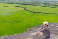 Seorang pelancong menikmati pemandangan perbukitan hijau yang asri sebagai bagian dari tren perjalanan pelan yang makin diminati masyarakat dunia. Interaksi yang tenang dengan alam terbuka menjadi pilihan utama untuk memulihkan kebugaran emosional di tengah kesibukan perkotaan.