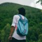 Seorang pelancong sedang menata barang bawaan dengan rapi sebelum memulai perjalanan. Pengemasan barang yang efisien menjadi salah satu kunci utama pengalaman liburan yang tenang dan menyenangkan.
